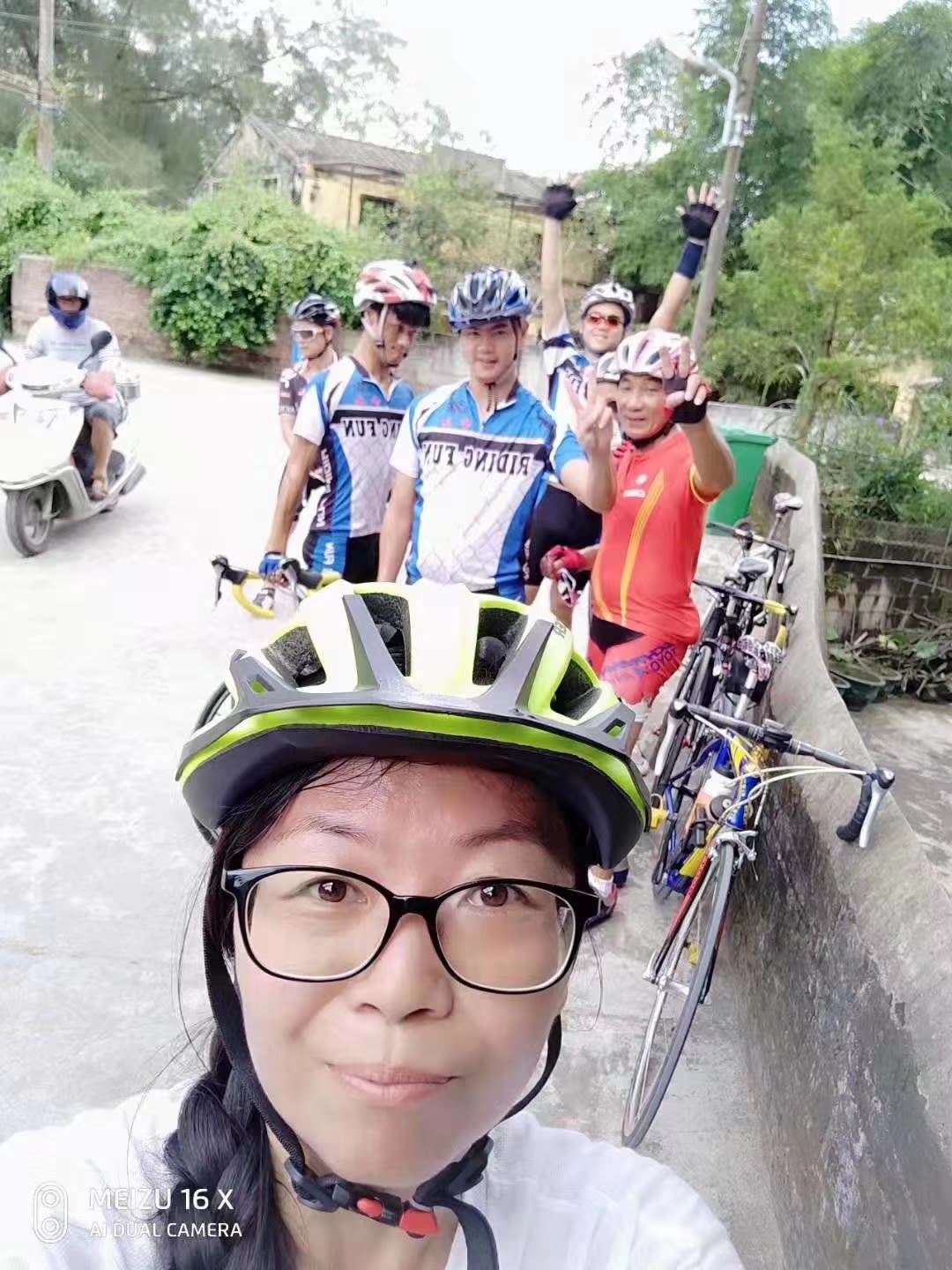 Ann Liang and Jerry Grey riding bikes with Zhongshan disabled cycle team.