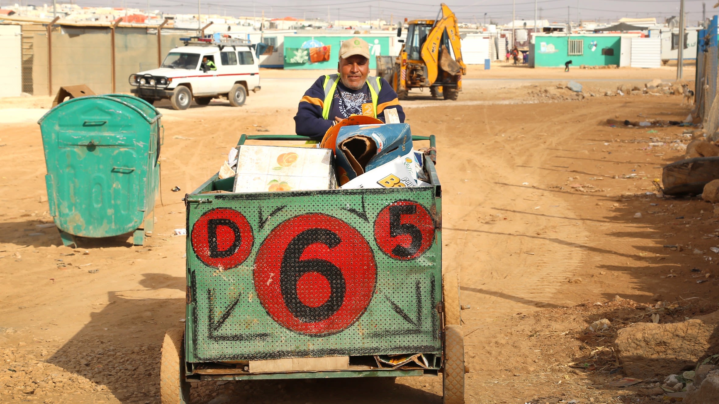 Refugees collect recyclable goods around the camp.