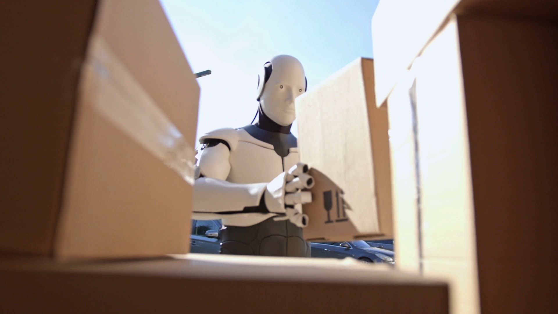 A humanoid robot moves boxes.