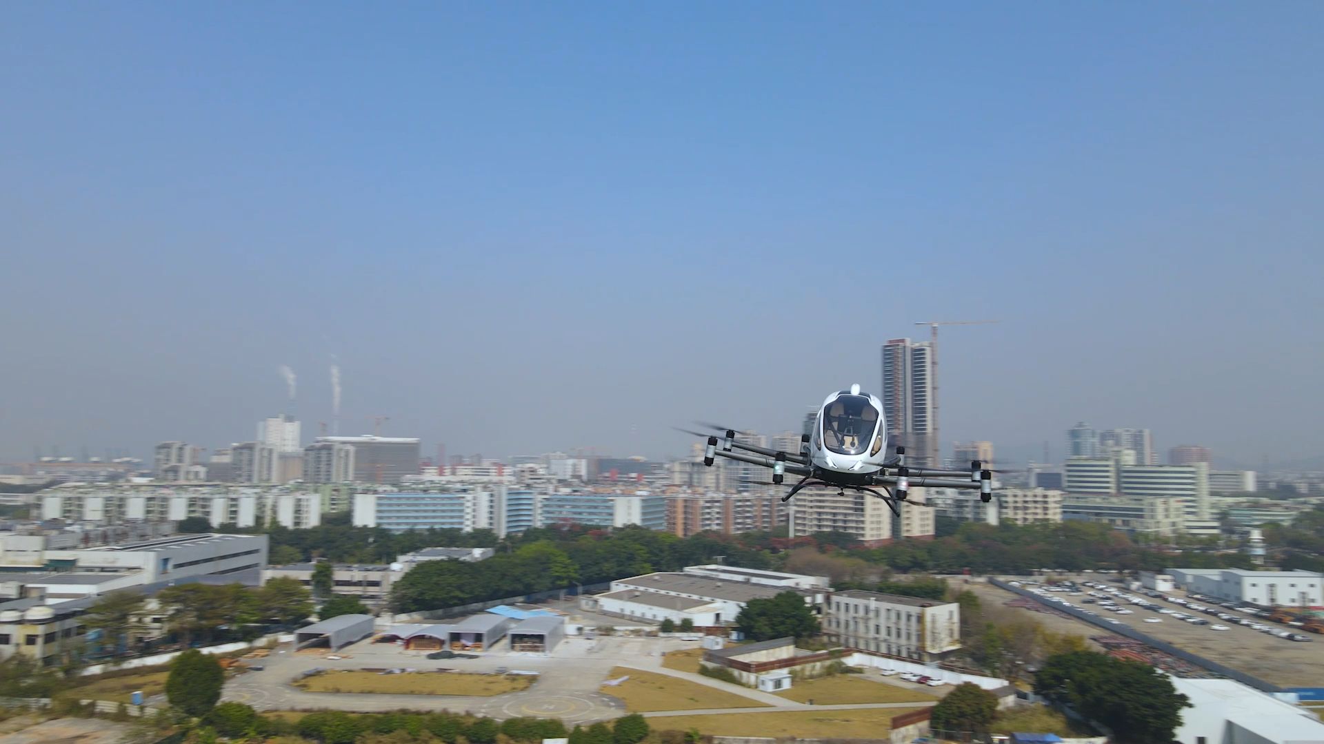A drone flies above a city