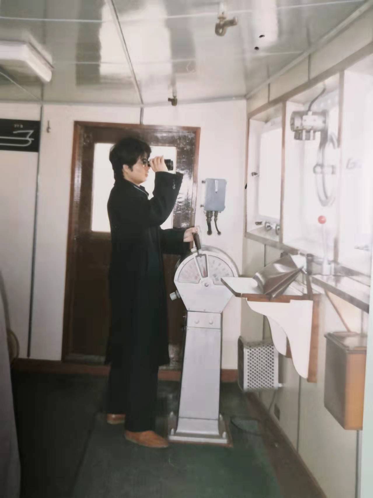 Liu navigating a vessel in the Chinese port of Nantong in 1990.