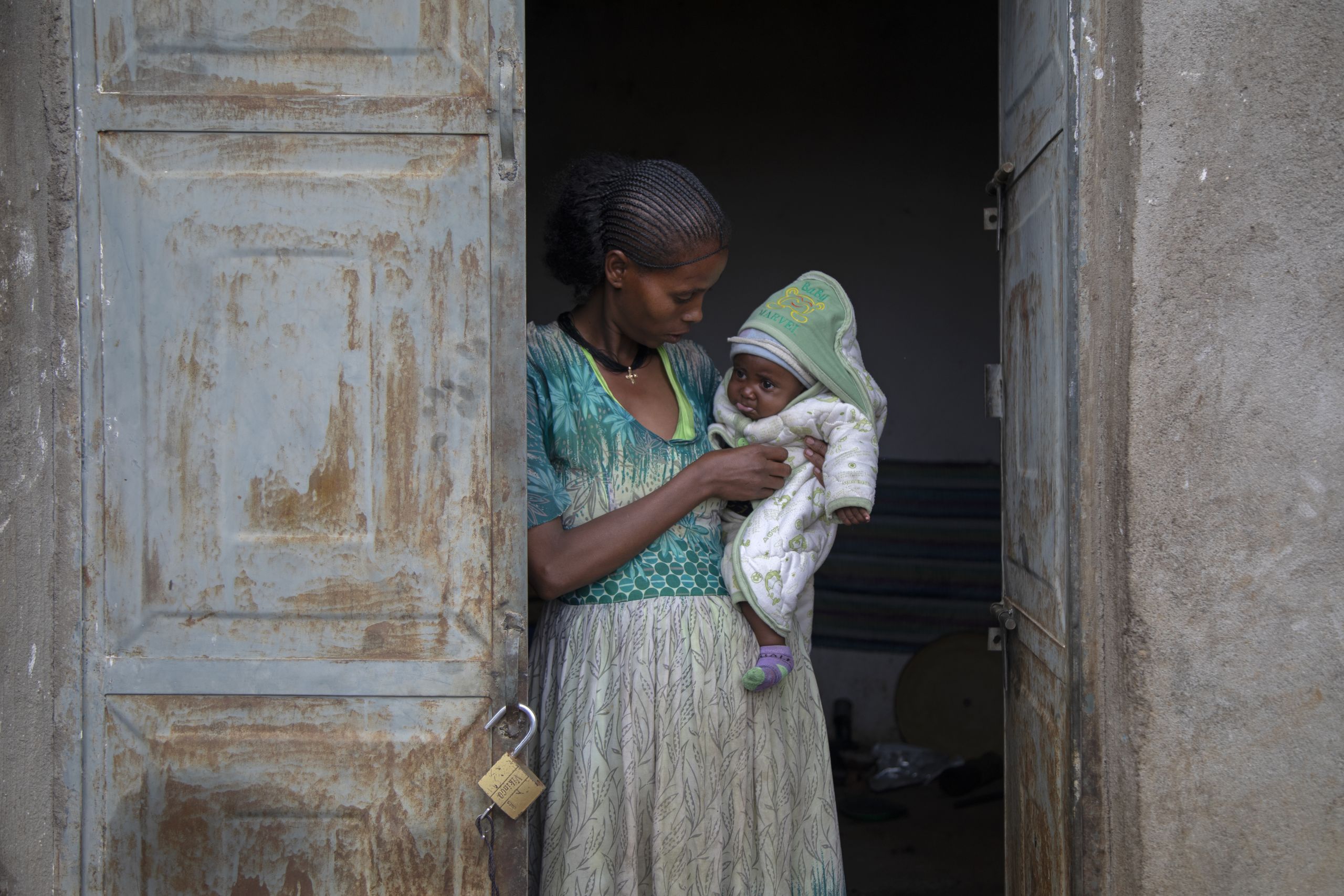 A severely acutely malnourished mother who fled fighting in Ethiopia nurses her acutely malnourished daughter.