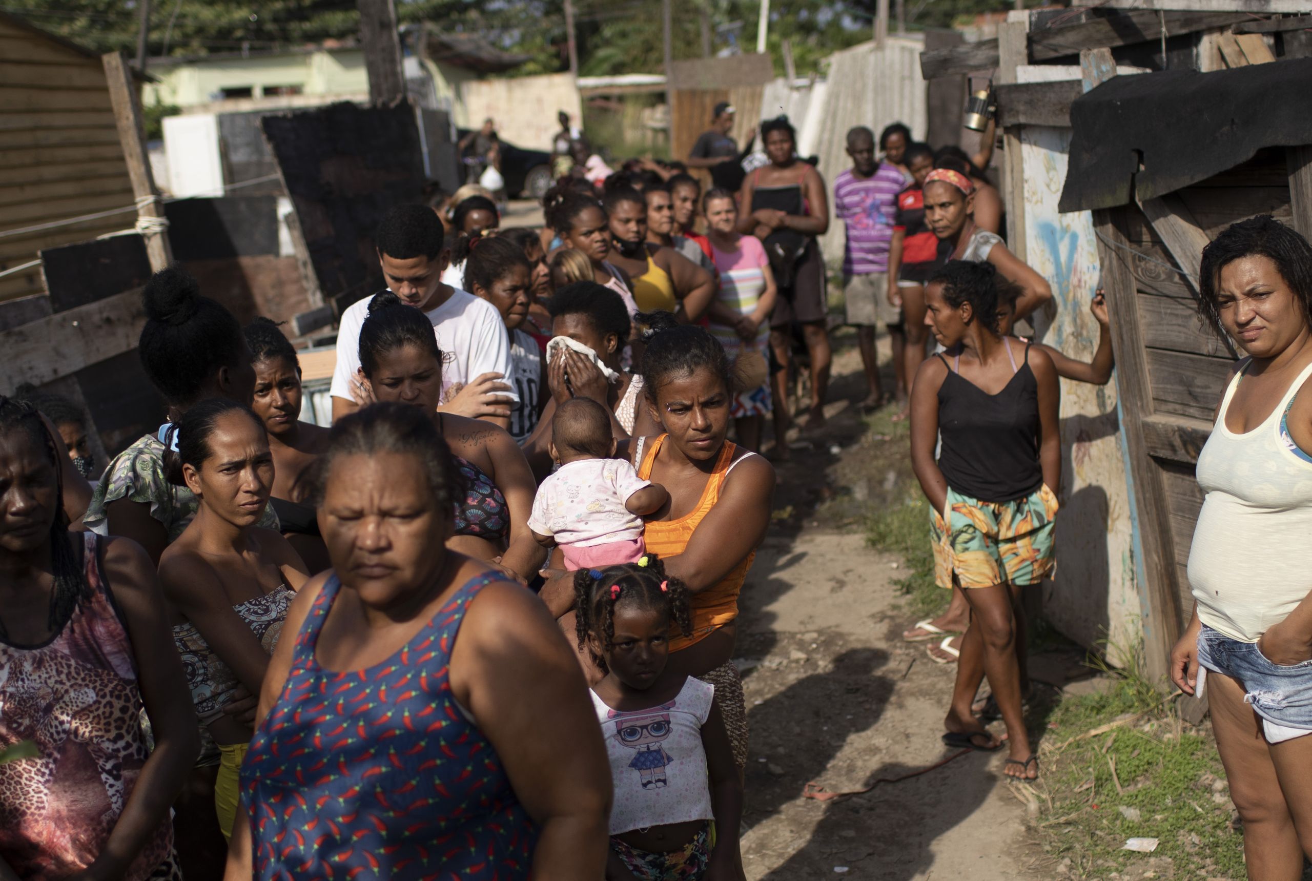 Women wait in line for food handouts in Rio de Janeiro, Brazil.