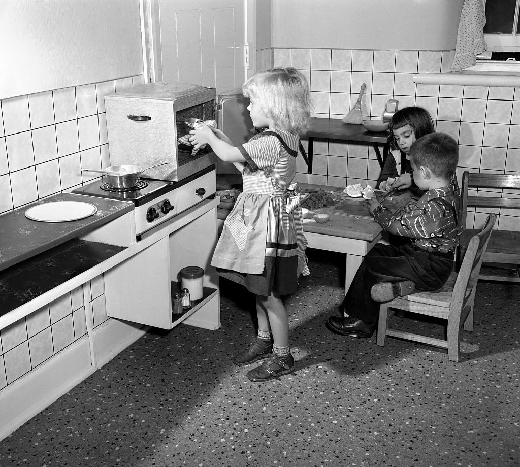 1950s children play in a toy kitchen – but did the increasing prevalence of antiseptic cleaners affect their health?