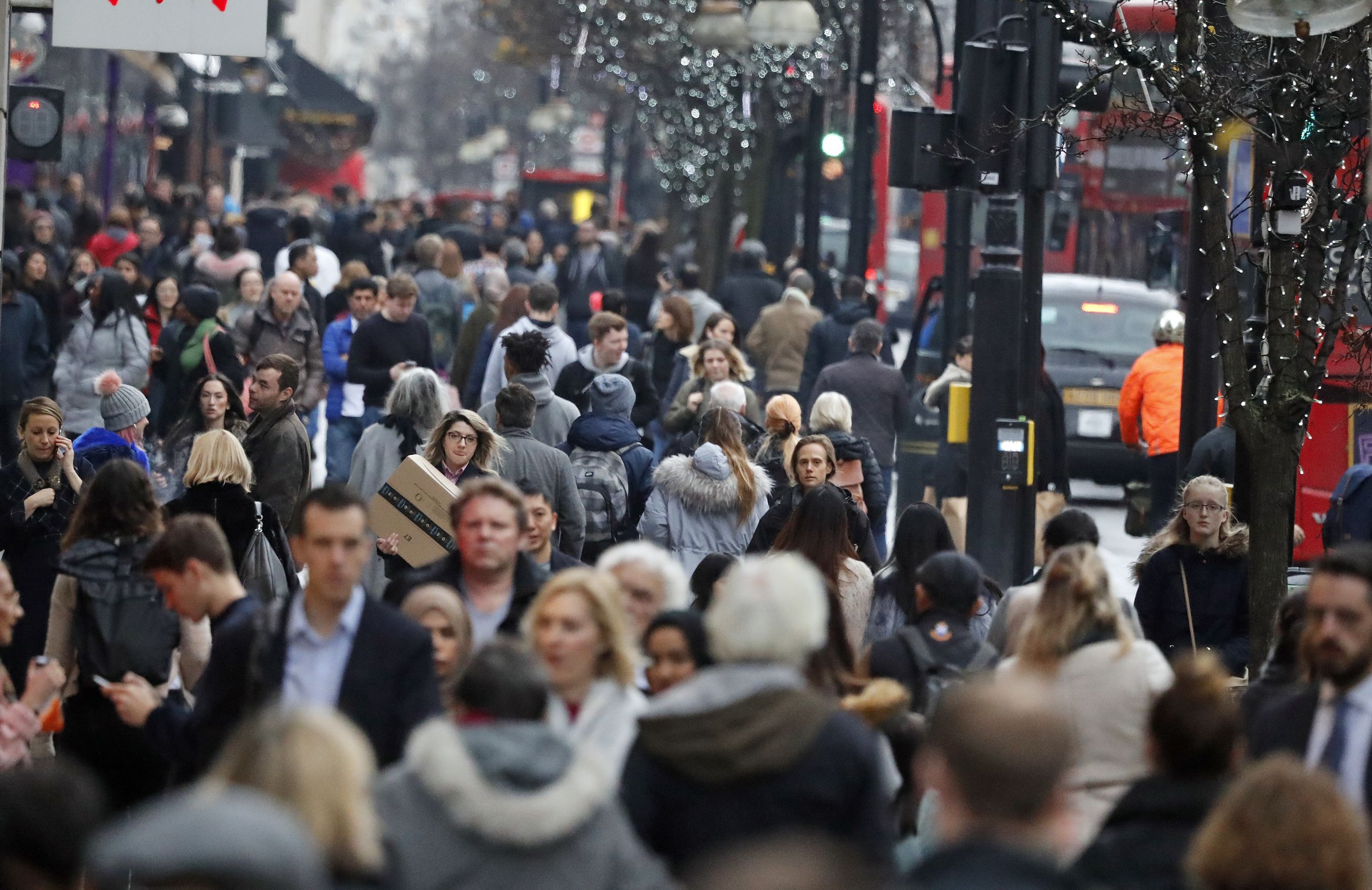 Shoppers walk along Oxford Street in London.
