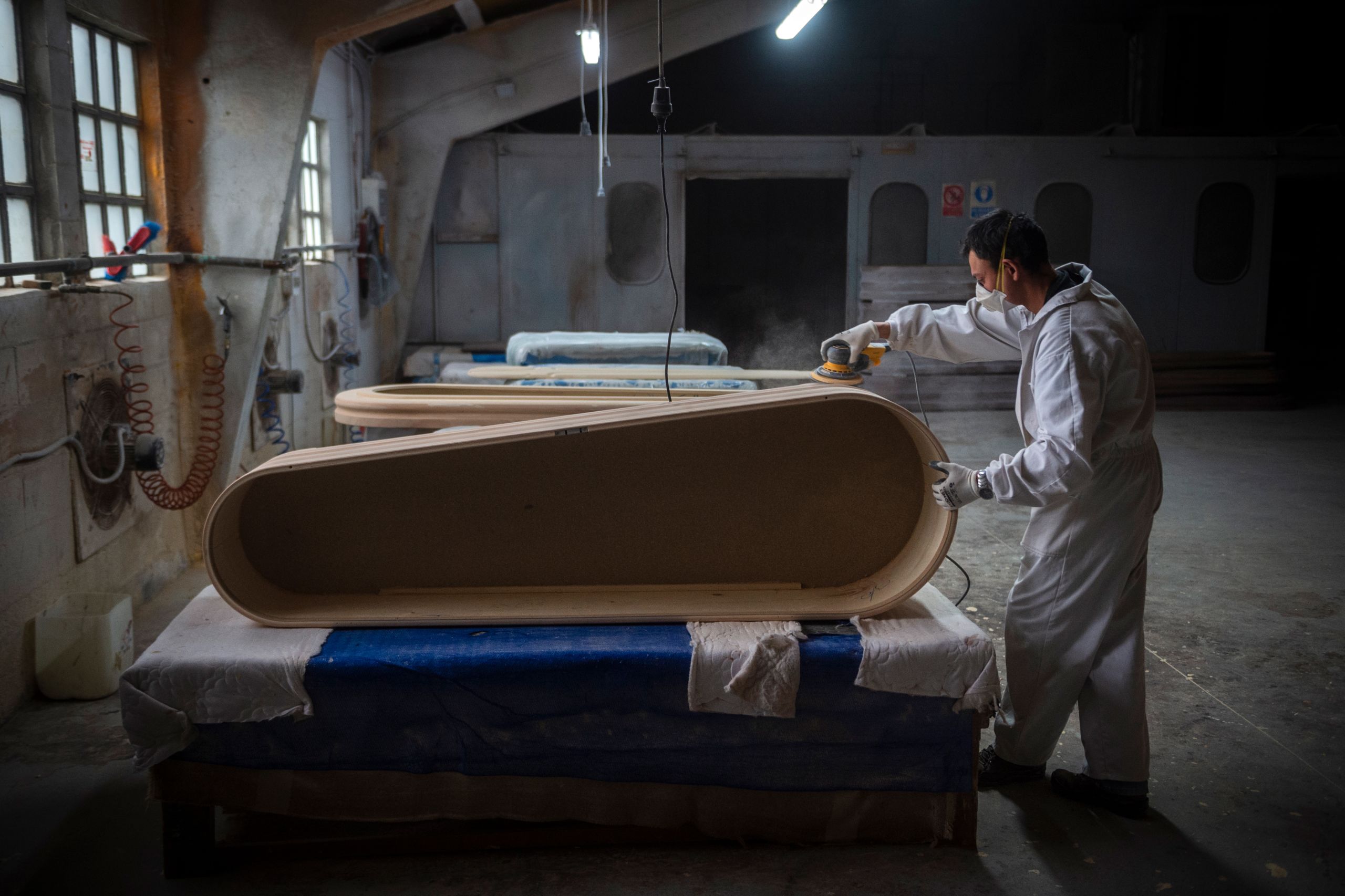 An employee makes a coffin at the Yago Gonzalez coffin-making factory in Pinor, northwestern Spain, on April 14, 2020. The Galician town of Pinor in northern Spain has just 1,100 inhabitants and a peculiarity--it has nine casket factories, which have doubled their production with the coronavirus pandemic.