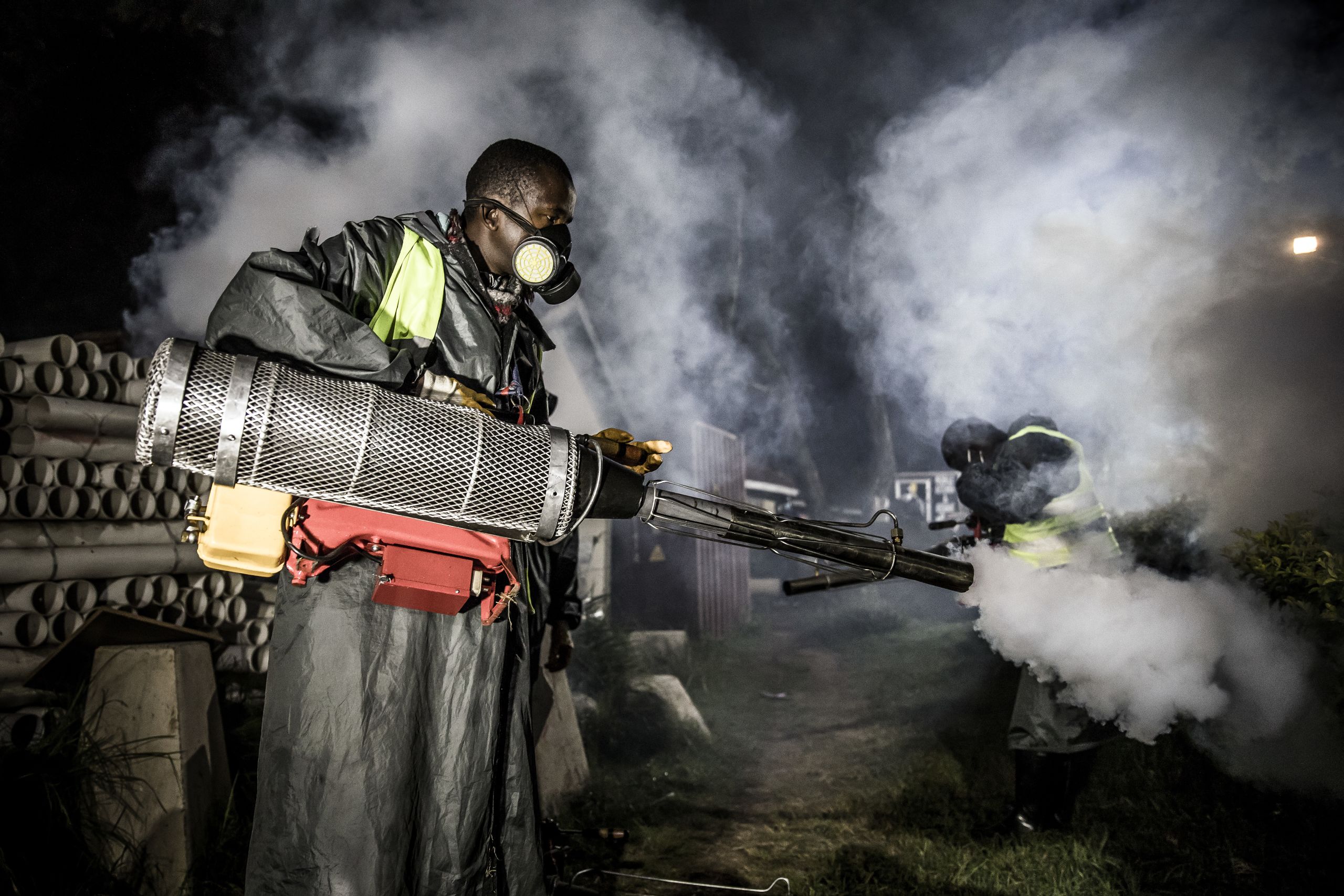 A member of a privately-funded NGO working with county officials wearing protective gear fumigates and disinfects on April 15, 2020, during the dusk-to-dawn curfew imposed by the Kenyan Government, the streets and the stalls at Parklands City Park Market in Nairobi to help curb the spread of the COVID-19 coronavirus.