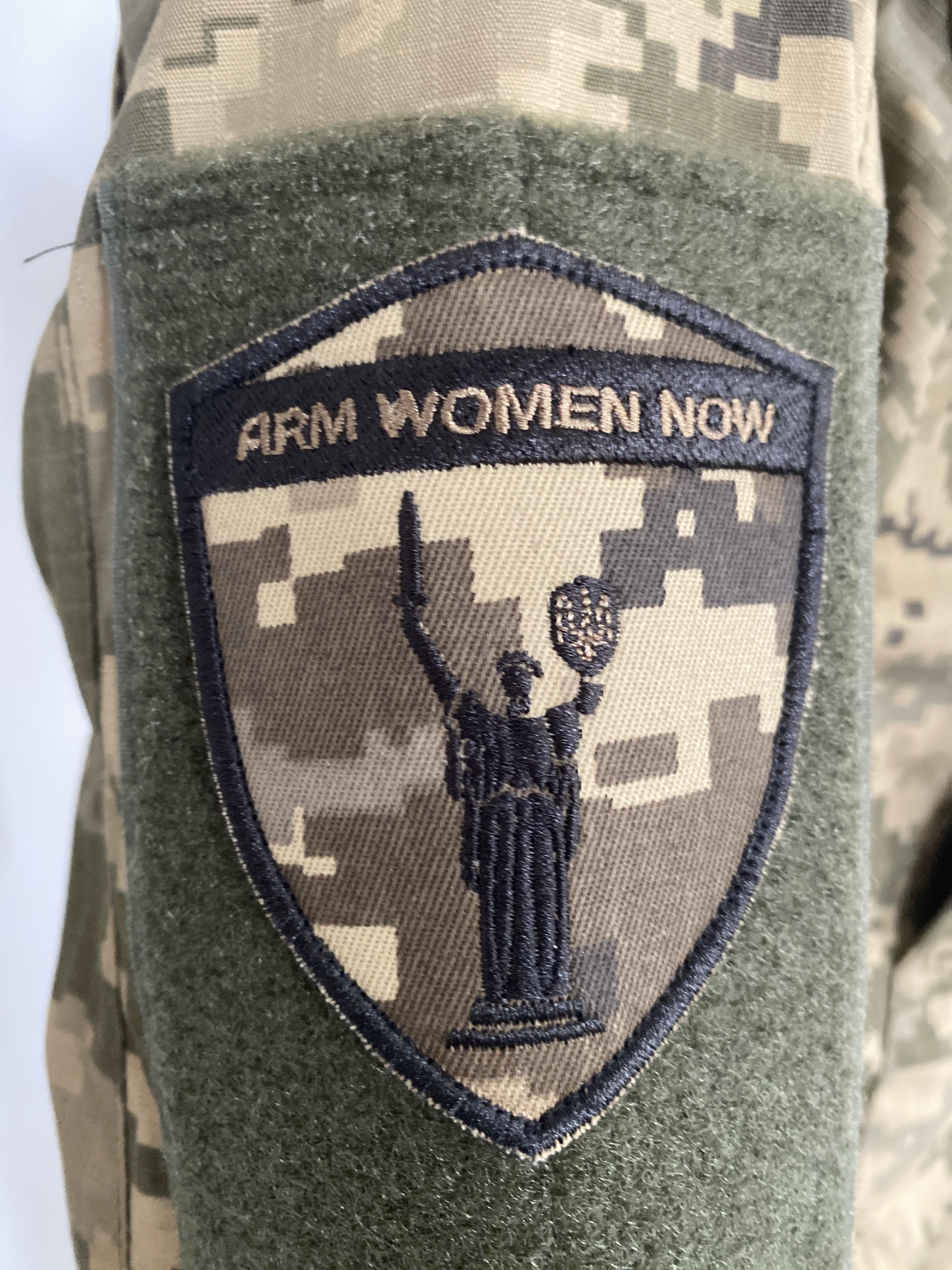 Arm Women Now badge.
