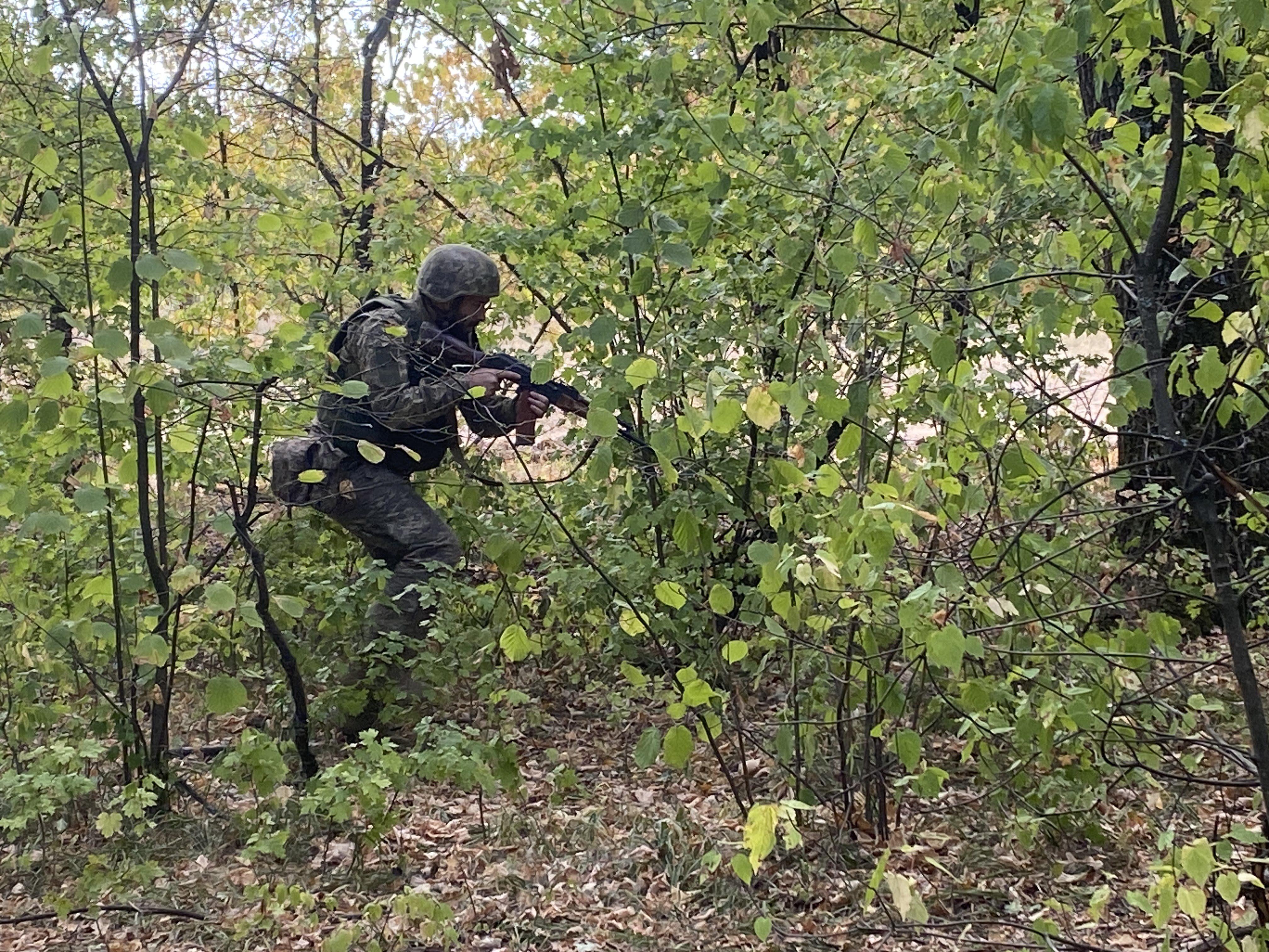 A soldier training in the woods.