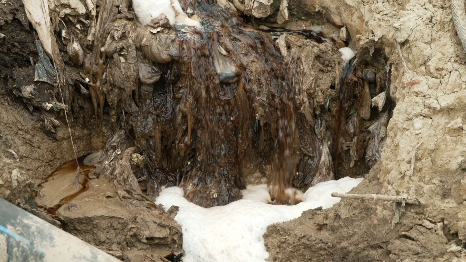 A natural stream through the dump becomes a toxins' thoroughfare.